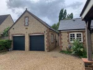 a brick house with two garage doors in a driveway at Park View Annexe 