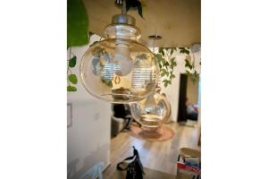 a glass light bulb hanging from a ceiling at Muy cómodo y moderno departamento en Zona Andares in Guadalajara +20 photos