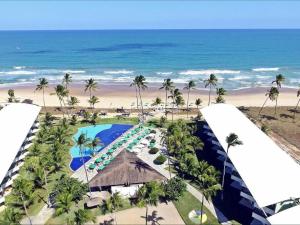 an aerial view of a resort with a pool and the beach at Best location of the development, ground floor seafront in Porto De Galinhas