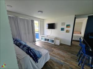 a living room with a bed and a mirror at Best location of the development, ground floor seafront in Porto De Galinhas