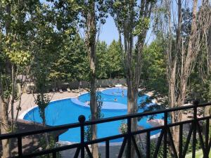 uma vista para uma piscina a partir de uma varanda em VOGUE HOTEL RESORT AND SPA - Nabran em Nabran