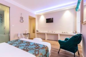 um quarto de hotel com uma cama e duas cadeiras em La Romantica camere e wellness em Senigallia