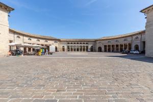 a large building with a courtyard with a lot of windows at La Romantica camere e wellness in Senigallia