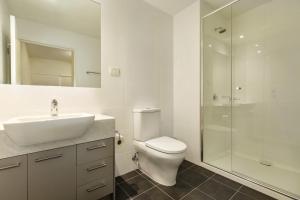 a bathroom with a toilet and a sink and a shower at Quest Melbourne Airport in Melbourne +41 photos