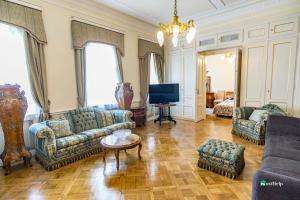 a living room with couches and a tv at Unique location with garden and terrace Old Town in Prague