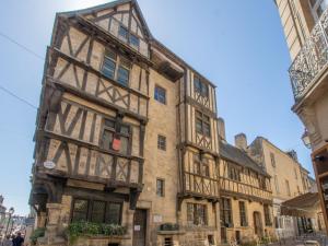 an old building in the middle of a street at Beautiful apartment in the historic center of Bayeux in Bayeux