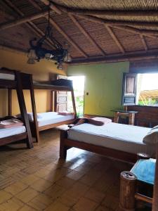a room with three bunk beds in a house at Paraíso de Mercedes in Pereira