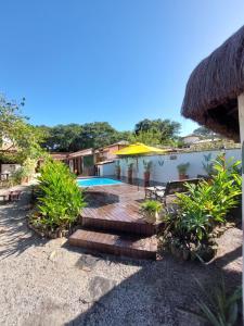 a resort with a swimming pool and a patio at Gambá Casa Boutique in Búzios