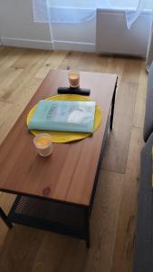 a wooden coffee table with two cups on top of it at *Street Clichy Art* - Appartement à 200 m de Paris ! in Clichy