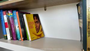 a row of books on a shelf at Casa Vista Summer in Karpathos Town