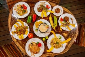 a table full of plates of food on a table at Hotel MadreSierra Parque Tayrona in Calabazo