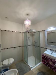 a bathroom with a shower and a toilet and a chandelier at Rome Sweet Home Vatican in Rome