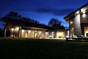 una casa iluminada por la noche con luces en La Transparence en Mazaye