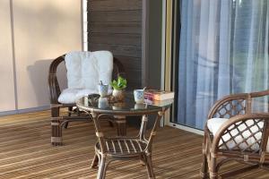 a living room with a table and a chair at La Transparence in Mazaye