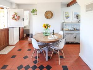a kitchen with a wooden table and chairs at Rose Cottage in Louth