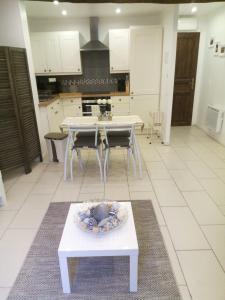 a kitchen with a table with a bowl on it at Maison de L'Amour Apartment Chardonnay in Assignan