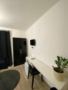 a white desk in a room with a potted plant at Rome Sweet Home Vatican in Rome