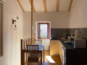 a small kitchen with a table and a window at Apartment Vesna in Skradin