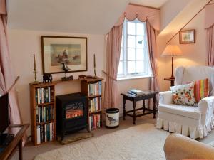 a living room with a fireplace and a fire place at White Rose Cottage in Robin Hood's Bay