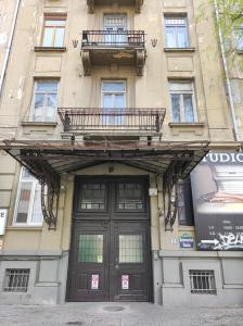 a building with a large door and a balcony above it at Scandinavian Home in Bucharest City Center in Bucharest