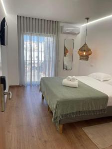 a bedroom with a bed with two towels on it at Pontinha Exclusive House in Faro