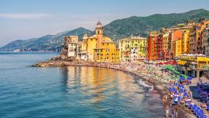 a group of people on a beach near the water at Camogli Eden - Luxury apartment in Camogli