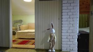 a statue of a bunny standing in a living room at Zeleni Čardaci etno apartmani in Kaludjerske Bare