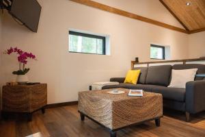 a living room with a couch and a table at Private Off Grid Cottage Nestled in Nature With Waterfront in Barrys Bay