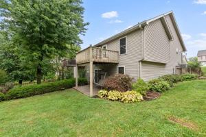 a house with a deck and a yard at Beautiful Townhome, 11 minutes to Downtown, KCMO. in Kansas City
