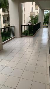 an empty balcony of a building with a white tile floor at JACO BAY in Jacó