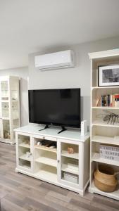 a white entertainment center with a flat screen tv at Slappe Jaén I in Jaén