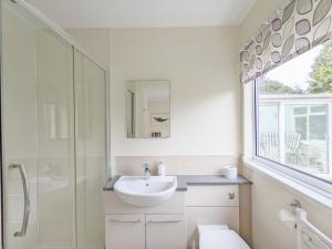 a white bathroom with a sink and a shower at Still Waters, Emsworth in Emsworth +27 photos