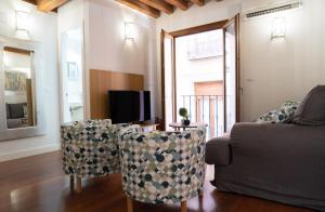 salon z kanapą, krzesłami i telewizorem w obiekcie Tres Culturas Lux w mieście Toledo