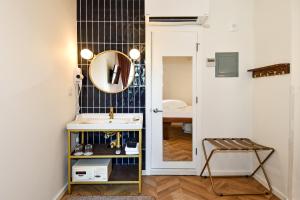 a bathroom with a sink and a mirror on the wall at HighRoad Washington DC in Washington, D.C. +96 photos