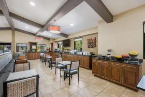 a large kitchen with tables and chairs in a restaurant at Best Western Asheville-Blue Ridge Parkway in Asheville