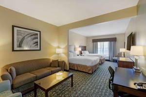 a hotel room with a bed and a couch at Best Western Plus Walkerton Hotel & Conference Centre in Walkerton +27 photos