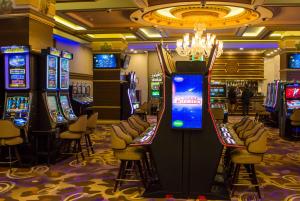 a casino with several slot machines in a room at Wyndham Batumi in Batumi