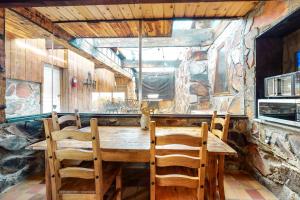 a dining room with a wooden table and chairs at Stone Temple in Yucca Valley