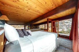 a bedroom with a bed and a large window at Stone Temple in Yucca Valley