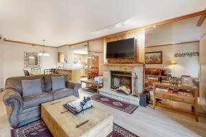 a living room with a couch and a fireplace at Park Station Condominiums 234 in Park City