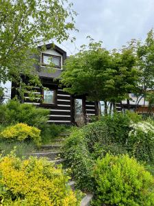 a black house with a balcony and some bushes at CANOA GUEST HOUSE A room - Vacation STAY 50937v in Ikeda