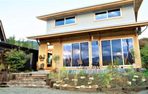 a large house with glass windows at CANOA GUEST HOUSE A room - Vacation STAY 50937v in Ikeda