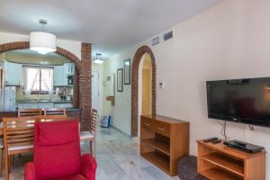a living room with a television and a dining room at Casa Maryna Calahonda by Casa del sol Holiday Rentals in Sitio de Calahonda