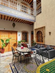 a patio with a table and chairs and a couch at Dar Rehab in Rabat
