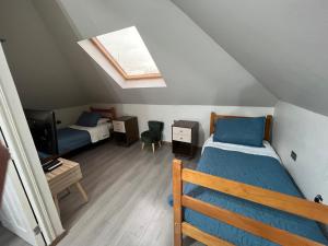 a attic bedroom with a bed and a tv at Gran Apart Hotel Chillan - Monte Piedra - Factura Empresas in Chillán