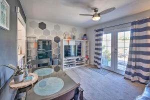 a living room with a table and a tv at 4 Mi to Beach Lake Havasu Apartment with Pool! in Lake Havasu City
