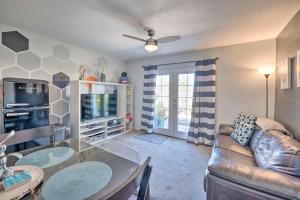 a living room with a couch a table and a tv at 4 Mi to Beach Lake Havasu Apartment with Pool! in Lake Havasu City