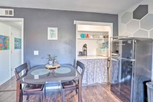 a dining room with a table and a refrigerator at 4 Mi to Beach Lake Havasu Apartment with Pool! in Lake Havasu City