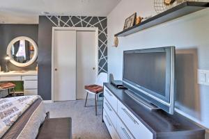 a bedroom with a large television on a dresser at 4 Mi to Beach Lake Havasu Apartment with Pool! in Lake Havasu City