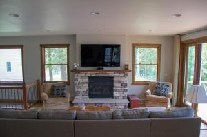 a living room with a couch and a fireplace at Lakefront Home 4 Bedroom 4 Bath Sleeps 12 in Waupaca